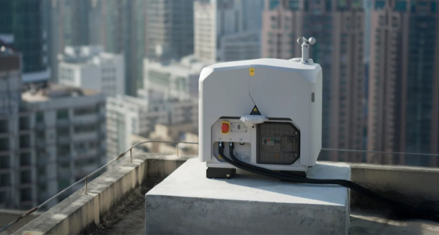 DJI Dock 3 installed on a rooftop with a city skyline behind it